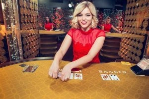 Players interacting in PHMYSTIC live baccarat casino room